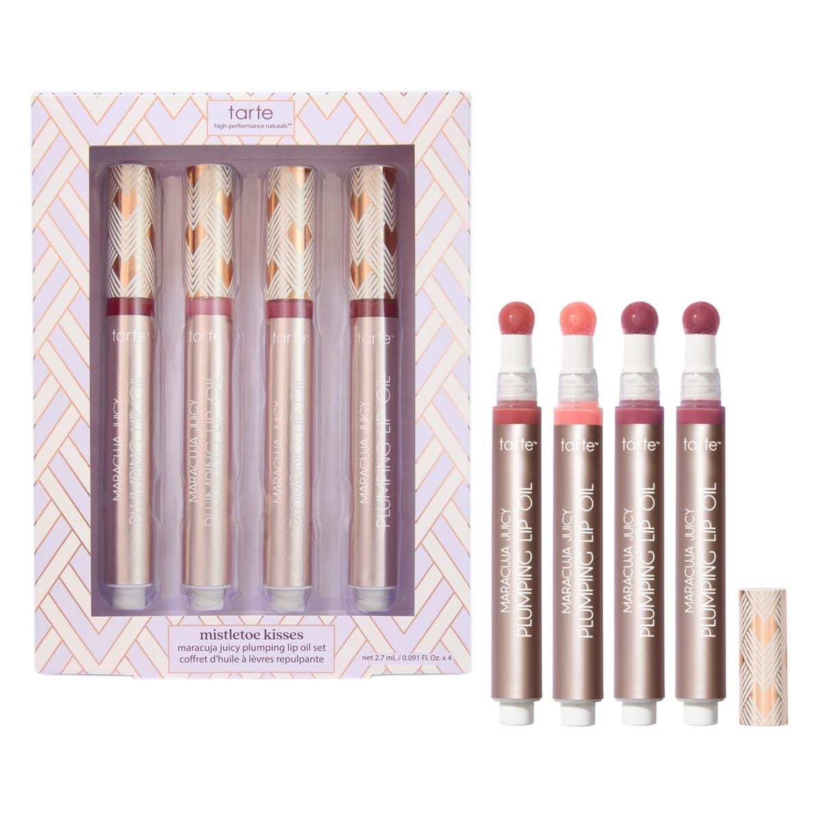 Tarte Maracuja Juicy Plumping Lip Oil set includes four shades with a sponge applicator in a decorative box labeled \“Mistletoe Kisses.\“
