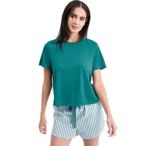 A woman is wearing a teal short-sleeve top paired with striped shorts featuring a drawstring waist.