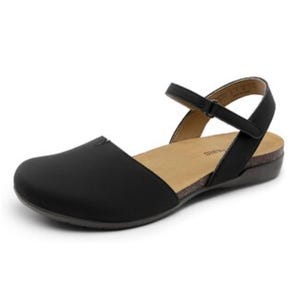 Black flat sandals with a closed toe, open back, and adjustable ankle strap. They have a cushioned insole and a slightly elevated sole, suitable for casual wear.