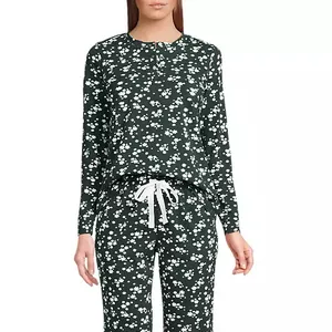 Two-piece loungewear set with a dark base and small white floral pattern, featuring a long-sleeve top and drawstring pants.