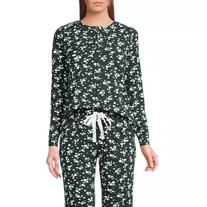 Two-piece loungewear set with a dark base and small white floral pattern, featuring a long-sleeve top and drawstring pants.