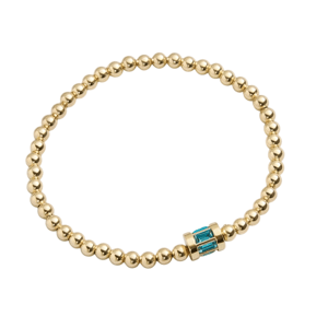 A gold beaded bracelet featuring a single blue accent piece.