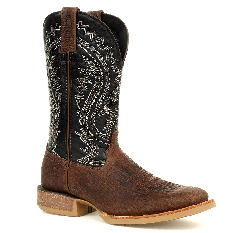 Brown leather cowboy boot with a textured finish, featuring a black shaft adorned with intricate zigzag stitching, a pull tab, and a square toe design.