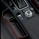 Car interior console featuring a gear shift, electronic parking brake, and control knobs.