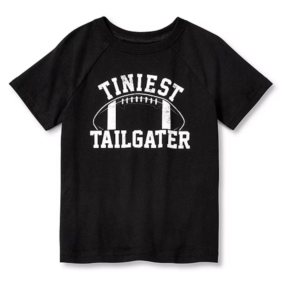 Black T-shirt with the text \“Tiniest Tailgater\“ and a football graphic in white.