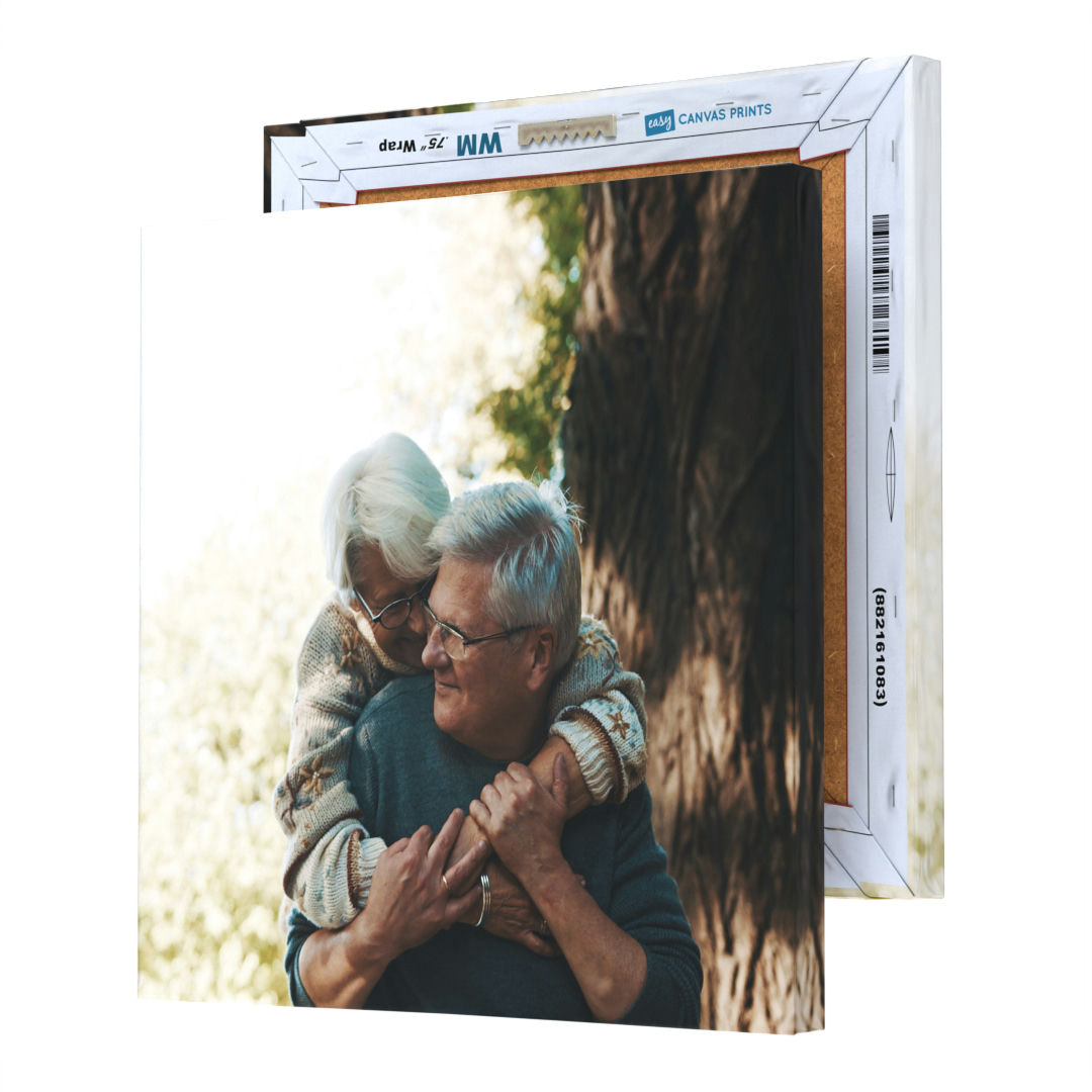 A canvas print depicting an affectionate moment between an elderly couple, presented in a cardboard box marked for canvas prints.