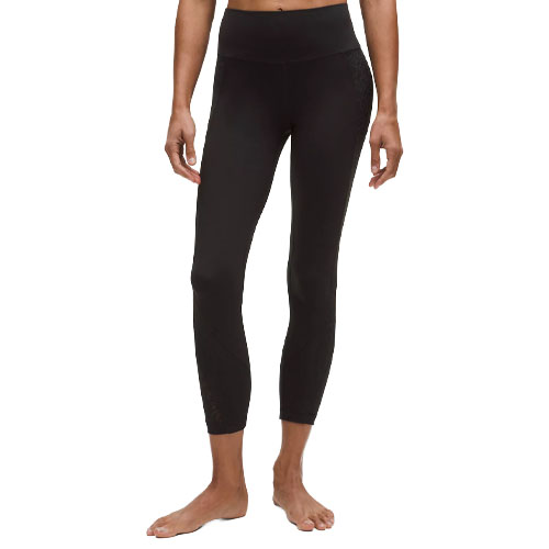 A person is wearing black high-waisted leggings with a cropped length, suitable for fitness or casual wear.