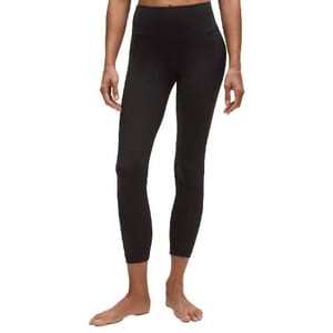 A person is wearing black high-waisted leggings with a cropped length, suitable for fitness or casual wear.