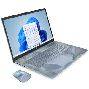 A laptop with a floral design on the keyboard and touchpad, running Windows 11, paired with a matching wireless mouse.