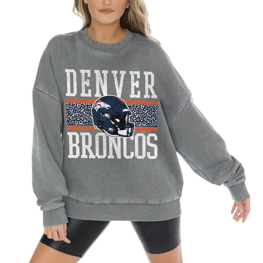 A gray oversized sweatshirt featuring \“Denver Broncos\“ text, a blue helmet with the team's logo, and an orange and blue patterned stripe across the chest.