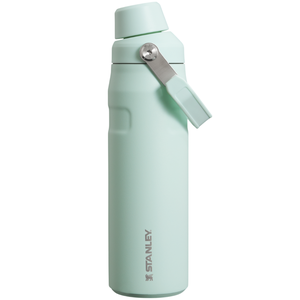 A light green Stanley water bottle with a flip top handle and a sleek, ergonomic design.