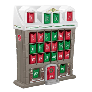 A plastic advent calendar shaped like a building with numbered doors from 1 to 25 in red and green, featuring a festive Christmas theme.