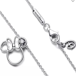 Silver necklace featuring a Minnie Mouse outline with a bow and sparkling gem, branded with \“PANDORA\“ on the clasp.