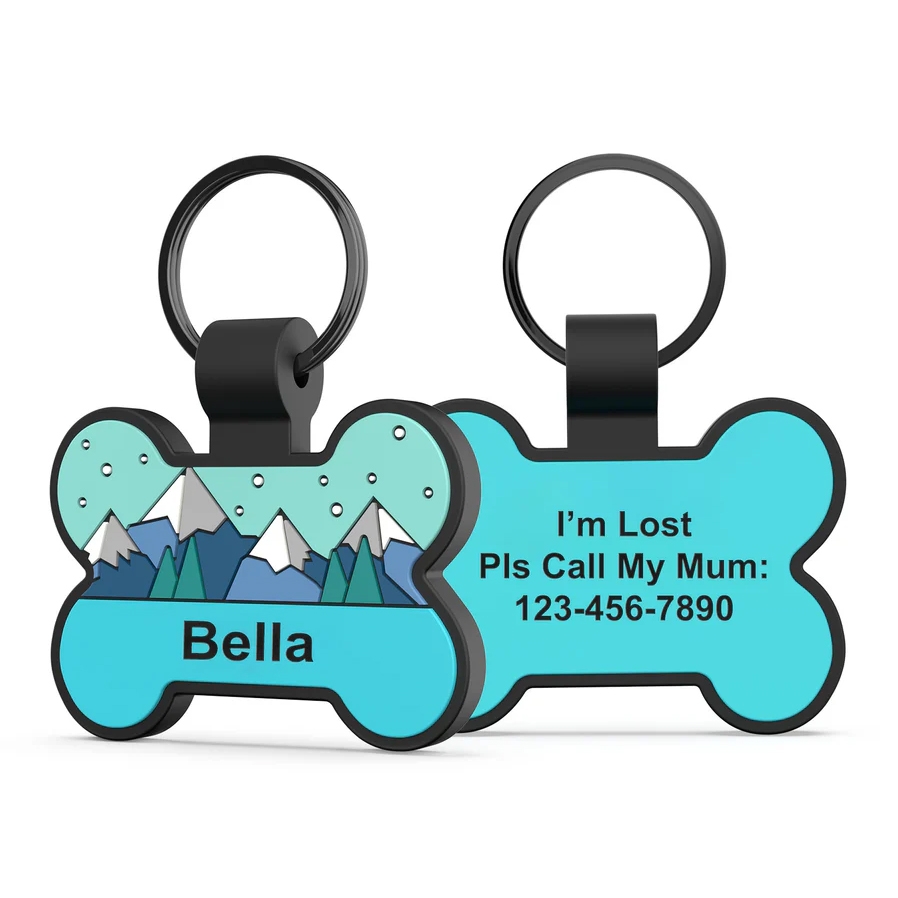 Bone-shaped silicone dog ID tag with a mountain design and the name \“Bella\“ on one side. The other side reads, \“I'm Lost Pls Call My Mum: 123-456-7890\“ in black text.