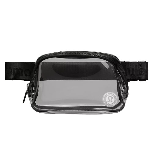 A clear, compact waist pack with a black strap and zipper, featuring a logo on the front corner.