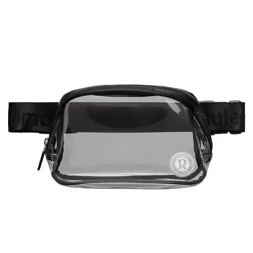 A clear, compact waist pack with a black strap and zipper, featuring a logo on the front corner.