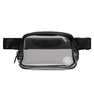 A clear, compact waist pack with a black strap and zipper, featuring a logo on the front corner.