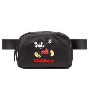 A black Lululemon belt bag featuring an embroidered Mickey Mouse design and the Lululemon logo.