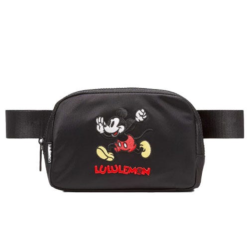 A black Lululemon belt bag featuring an embroidered Mickey Mouse design and the Lululemon logo.