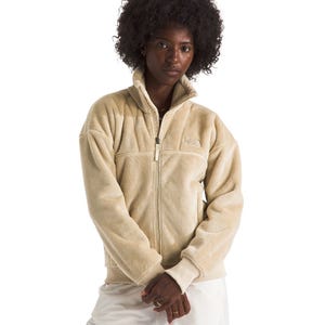 The North Face Women's Osito Lux Bomber is a plush, beige zip-up fleece jacket with a high collar and ribbed cuffs.