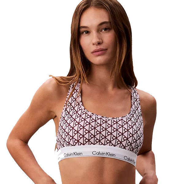 A woman wears a Calvin Klein sports bra with a geometric pattern and a branded elastic band.