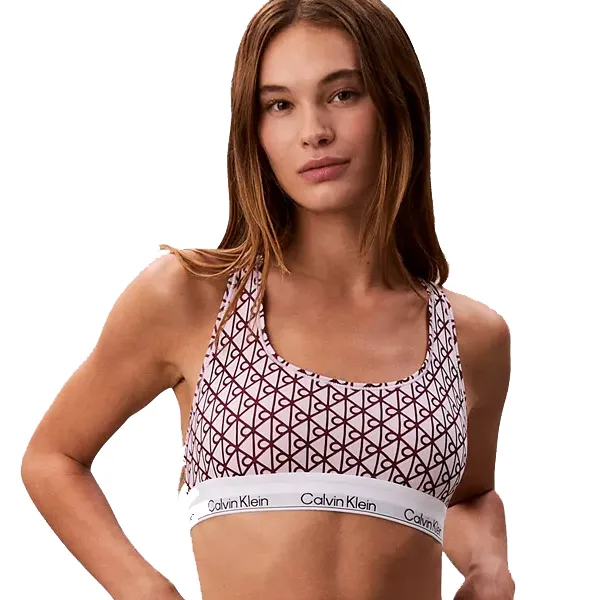 A woman wears a Calvin Klein sports bra with a geometric pattern and a branded elastic band.