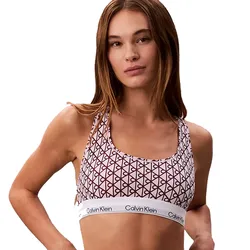 A woman wears a Calvin Klein sports bra with a geometric pattern and a branded elastic band.