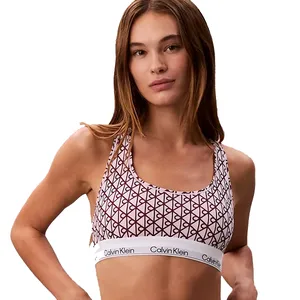 A woman wears a Calvin Klein sports bra with a geometric pattern and a branded elastic band.