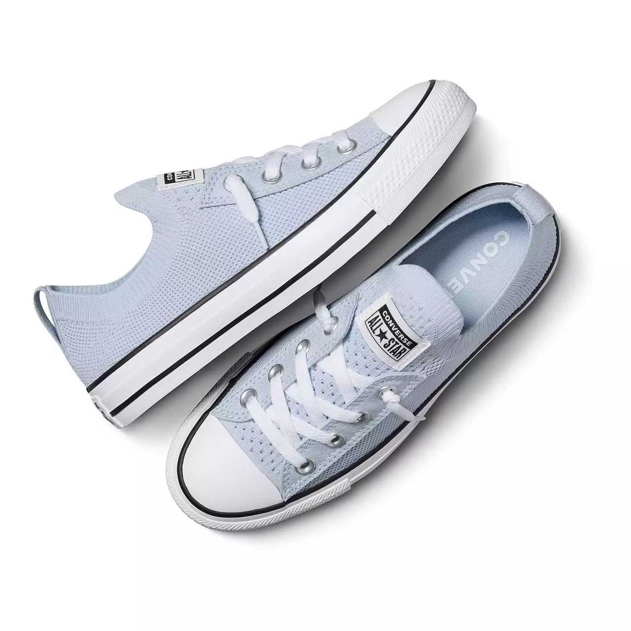 A pair of light blue canvas low-top sneakers with white laces and rubber soles.