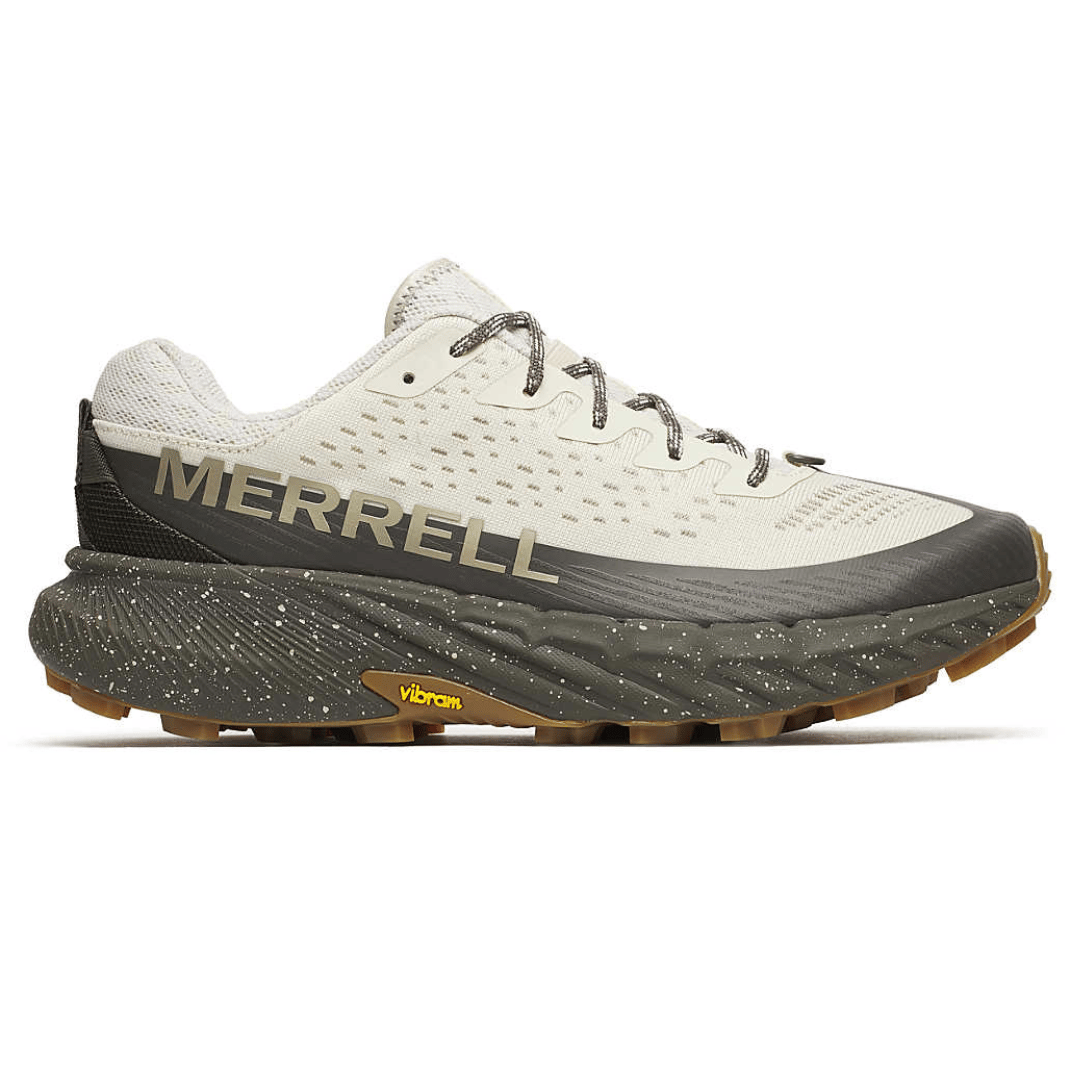 Merrell trail running shoe with a beige and dark gray color scheme, featuring a Vibram sole and speckled midsole design.
