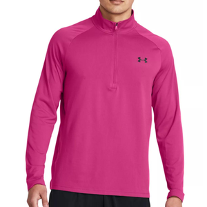 A person wearing a bright pink, long-sleeved athletic pullover with a zip-up collar and a black logo on the upper right chest.