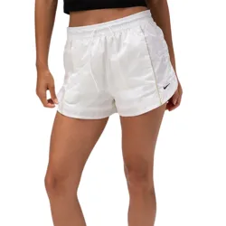 A person is wearing white Nike shorts with a small logo and matching Nike sneakers. The look is completed with a black top and white socks.