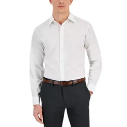 A man is wearing a white long-sleeve dress shirt, dark trousers, and a brown belt.