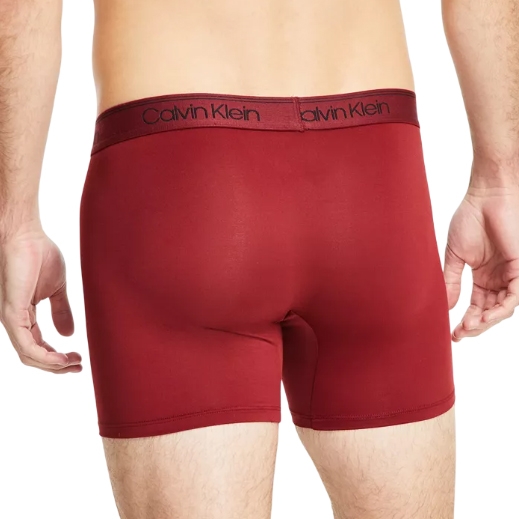 A pair of red Calvin Klein boxer briefs with a black logo on the waistband. Made from a smooth, stretchy fabric for comfort and fit.
