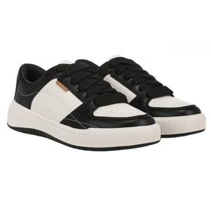 Dr. Scholl's Ollie Sneakers are low-top shoes featuring a black and white color scheme. They have black laces, perforated detailing on the toe, a textured white sole, and a small metal accent on the side.