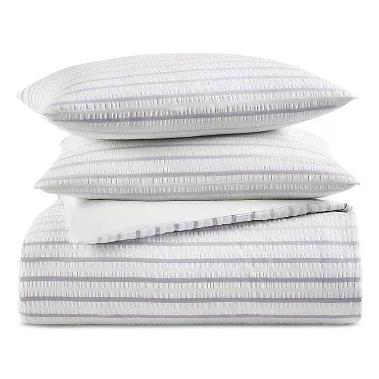 The Charter Club Seersucker Comforter Set includes a comforter and matching pillow shams, featuring a textured striped design in white and gray.