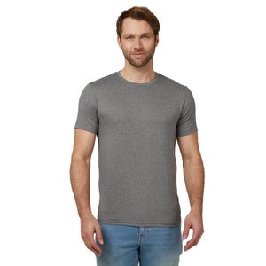 A man is wearing a gray short-sleeve T-shirt and light blue jeans, standing against a plain background.