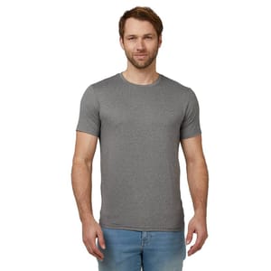 A man is wearing a gray short-sleeve T-shirt and light blue jeans, standing against a plain background.