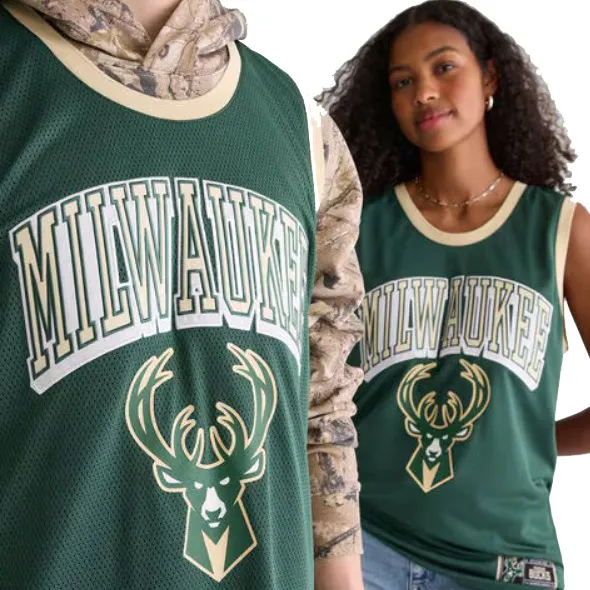 Green Milwaukee Bucks basketball jerseys featuring the team logo and name. One is worn over a camouflage hoodie and the other with jeans, both with ribbed collars.