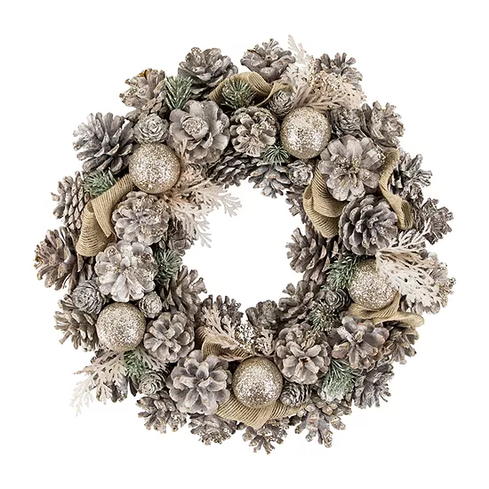 A decorative wreath featuring frosted pinecones, glittering silver balls, and artificial foliage in muted tones.