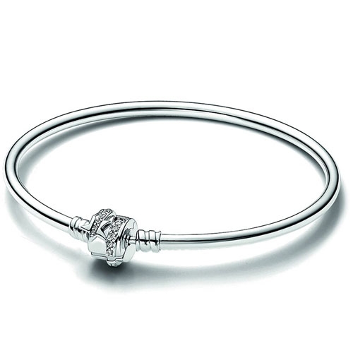 A sleek bracelet featuring a smooth silver band with a decorative clasp adorned with small details.