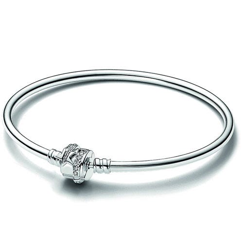 A sleek bracelet featuring a smooth silver band with a decorative clasp adorned with small details.