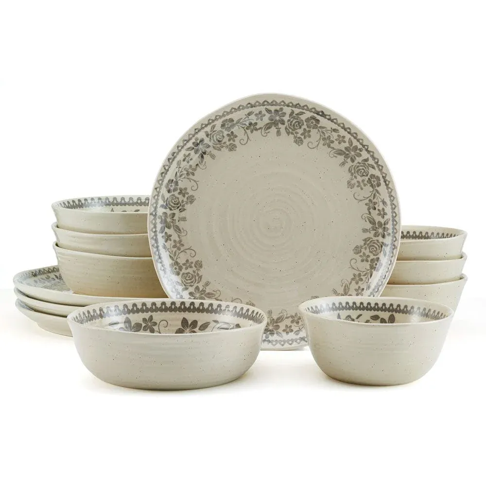 A ceramic dinnerware set with a floral pattern, including plates, bowls, and larger serving dishes, in a neutral beige tone.