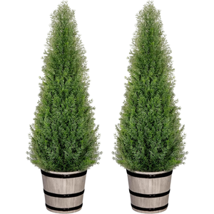 Two artificial cedar trees in rustic wooden pots, designed for decorative purposes.