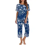 A woman is wearing a blue floral-patterned pajama set with short sleeves and calf-length pants.
