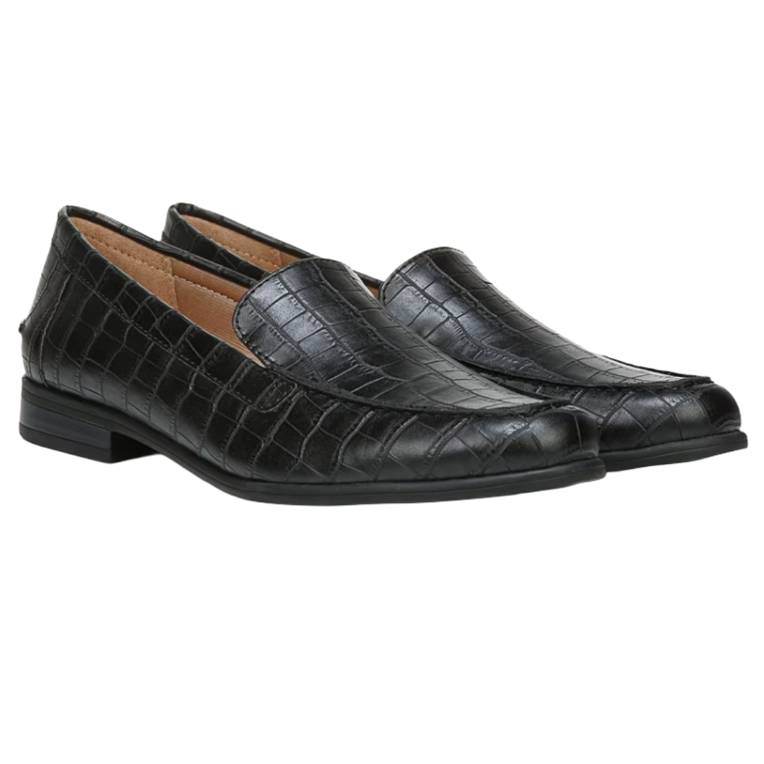 A pair of black loafers with a crocodile texture and low heel.