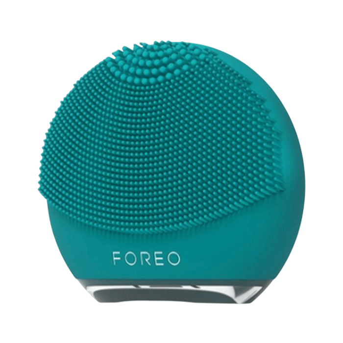 A teal-colored Foreo facial cleansing brush with silicone bristles designed for skincare routines.