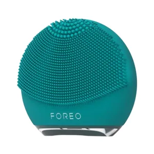 A teal-colored Foreo facial cleansing brush with silicone bristles designed for skincare routines.