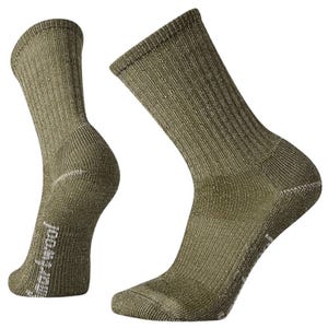 A pair of olive green crew socks with a ribbed texture and reinforced heel and toe, suitable for outdoor activities.