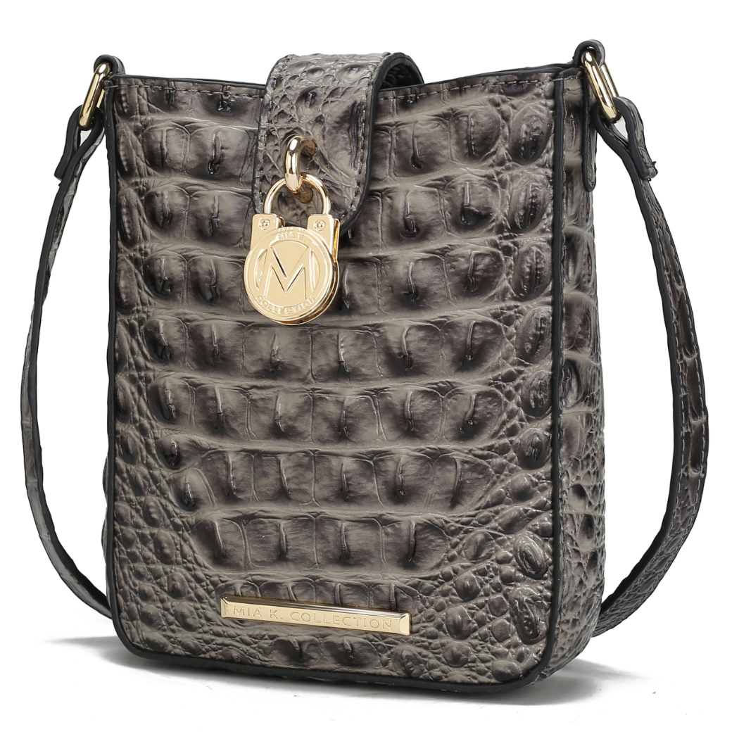 A grey embossed crossbody bag with a crocodile texture, featuring gold hardware, an \“M\“ emblem, and a \“MIA K COLLECTION\“ nameplate.